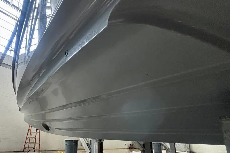  Yacht Photos Pics 2024 Axopar 37 XC Cross Cabin hull in a boatyard setting.
