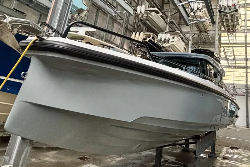  Yacht Photos Pics 2024 Axopar 37 XC Cross Cabin boat in indoor storage facility.