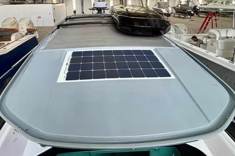  Yacht Photos Pics 2024 Axopar 37 XC Cross Cabin with solar panel on roof in a showroom.