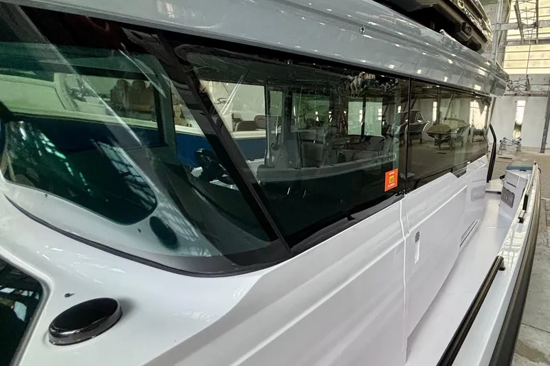  Yacht Photos Pics 2024 Axopar 37 XC Cross Cabin boat, side view with sleek design and large windows.