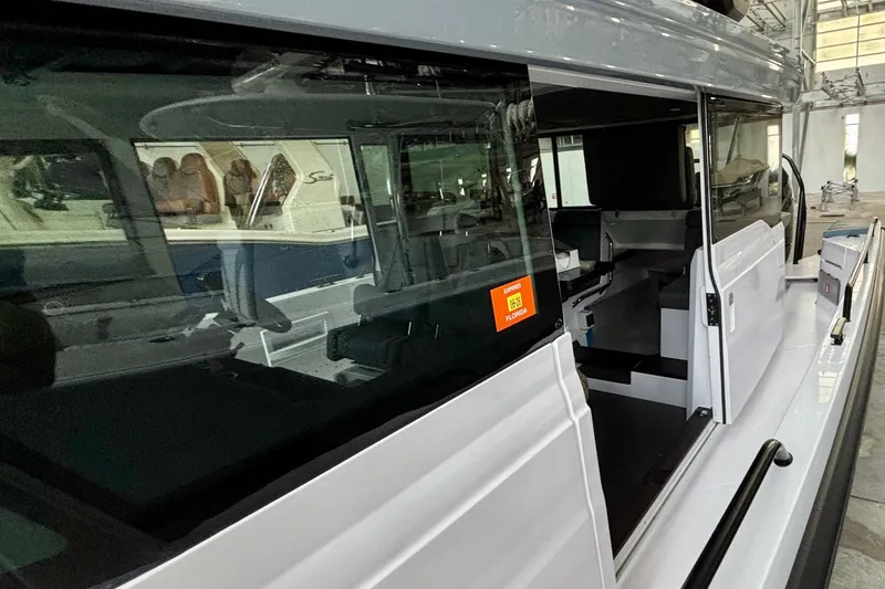  Yacht Photos Pics 2024 Axopar 37 XC Cross Cabin boat interior view in a showroom setting.