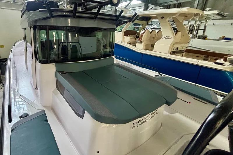  Yacht Photos Pics 2024 Axopar 37 XC Cross Cabin boat in a showroom, featuring sleek design and modern amenities.
