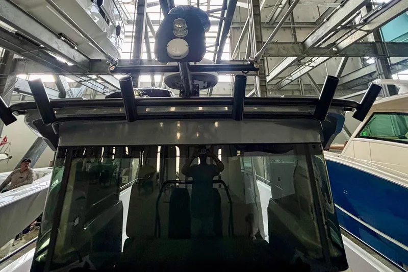  Yacht Photos Pics 2024 Axopar 37 XC Cross Cabin in a boat storage facility, showcasing its front design.