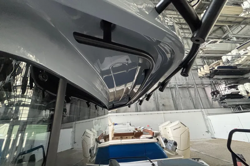  Yacht Photos Pics 2024 Axopar 37 XC Cross Cabin in a storage facility, showcasing sleek design and powerful engines.