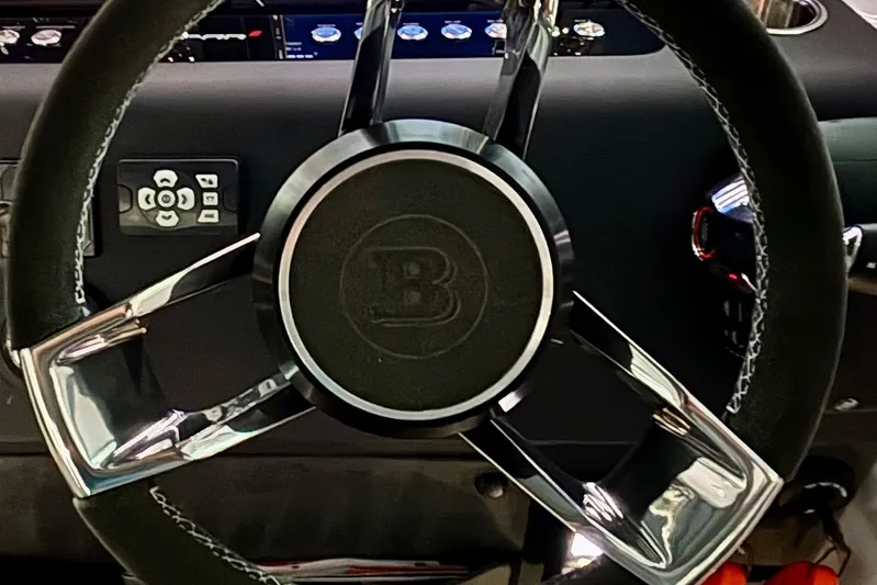  Yacht Photos Pics Steering wheel of 2024 Axopar 37 XC Cross Cabin boat, featuring sleek design and controls.