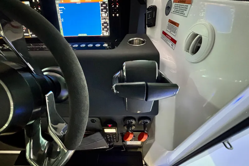  Yacht Photos Pics 2024 Axopar 37 XC Cross Cabin helm with steering wheel and control panel.