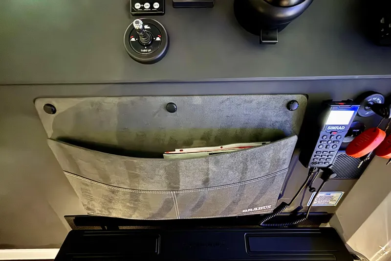  Yacht Photos Pics Control panel of 2024 Axopar 37 XC Cross Cabin with storage pocket and Simrad device.