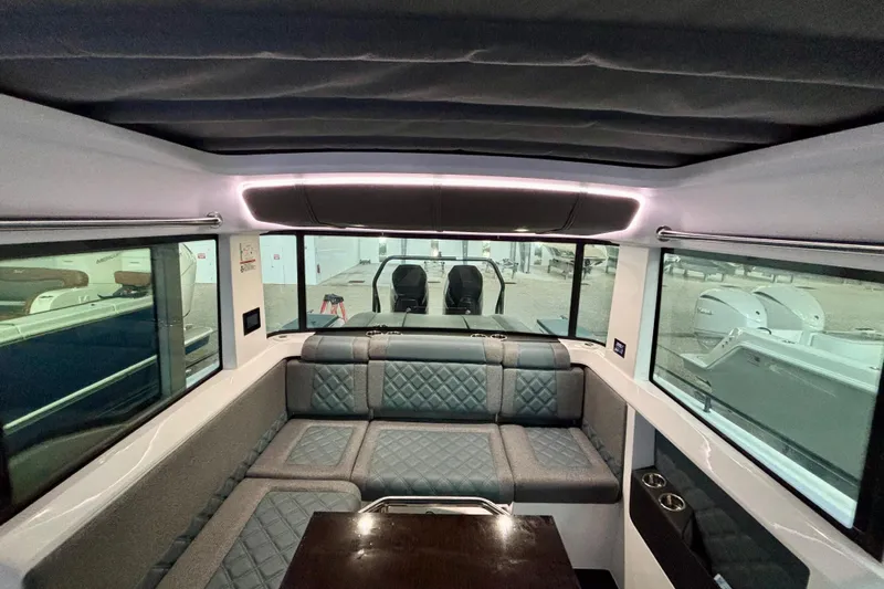  Yacht Photos Pics Interior of 2024 Axopar 37 XC Cross Cabin with plush seating and panoramic windows.