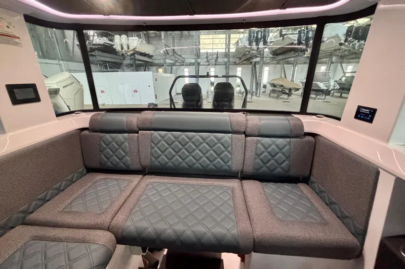  Yacht Photos Pics 2024 Axopar 37 XC Cross Cabin interior with quilted seating and panoramic windows.