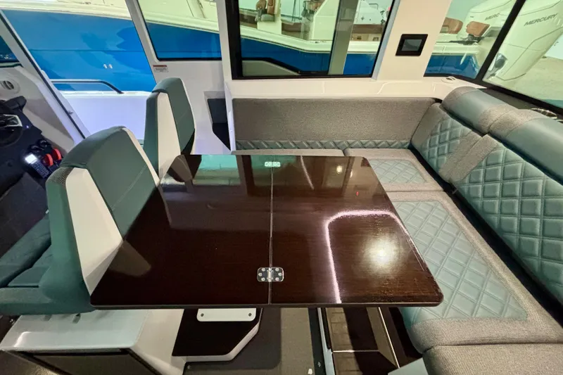  Yacht Photos Pics 2024 Axopar 37 XC Cross Cabin interior with elegant seating and polished table.