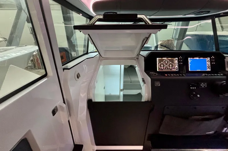  Yacht Photos Pics 2024 Axopar 37 XC Cross Cabin interior with navigation displays and cabin access.