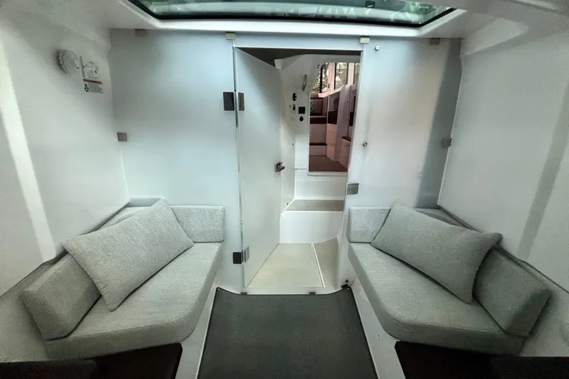  Yacht Photos Pics 2024 Axopar 37 XC Cross Cabin interior with modern seating and sleek design.