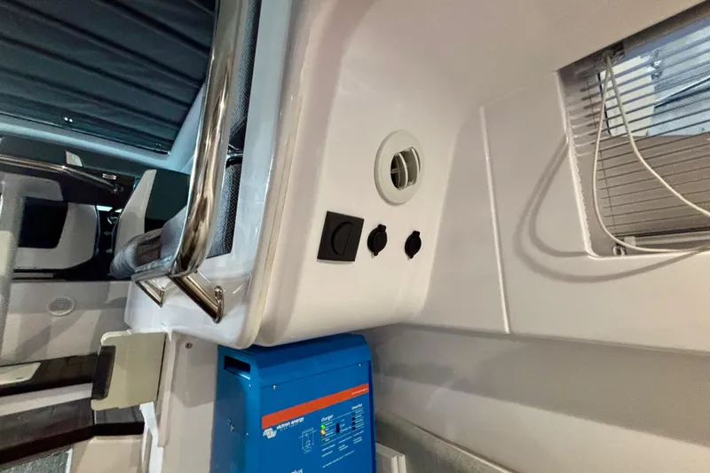  Yacht Photos Pics 2024 Axopar 37 XC Cross Cabin interior with control panel and seating.