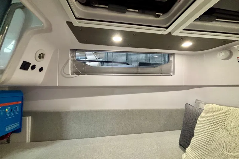  Yacht Photos Pics 2024 Axopar 37 XC Cross Cabin interior with modern seating and window blinds.