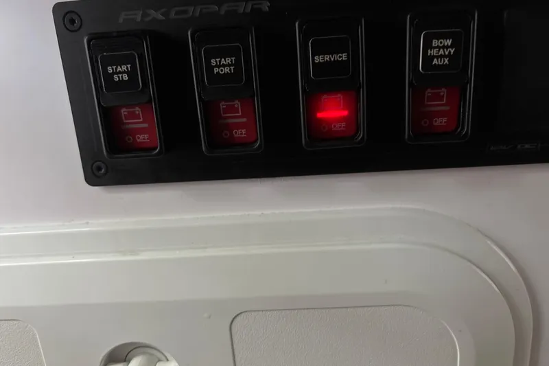  Yacht Photos Pics Control panel of 2024 Axopar 37 XC Cross Cabin with labeled switches.