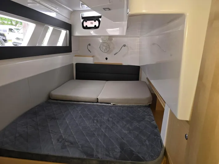  Yacht Photos Pics Cozy cabin interior of 2025 Seawind 1370 yacht with modern bedding and sleek design.