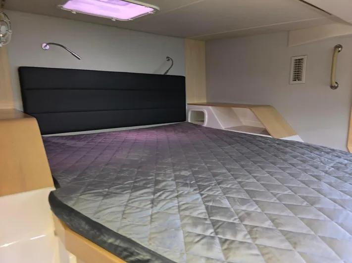  Yacht Photos Pics 2025 Seawind 1370 cabin interior with quilted bed, modern design, and soft lighting.