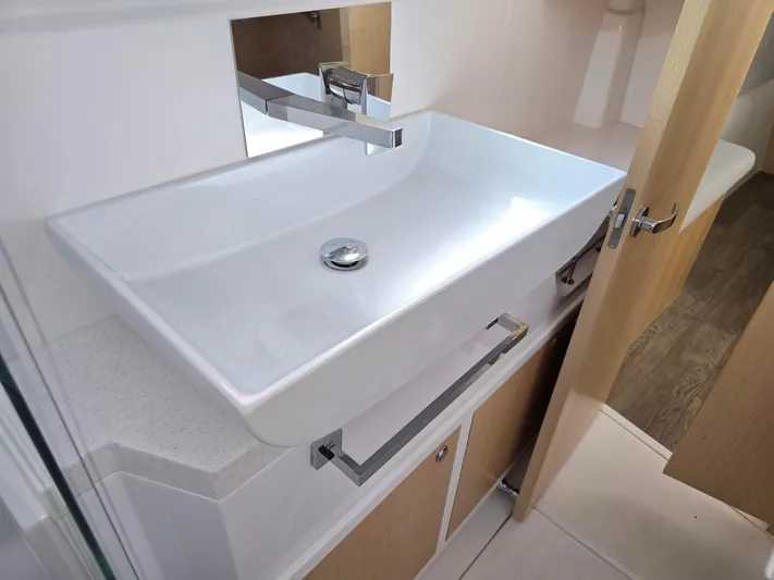  Yacht Photos Pics Modern bathroom sink in 2025 Seawind 1370 yacht, featuring sleek design and chrome fixtures.