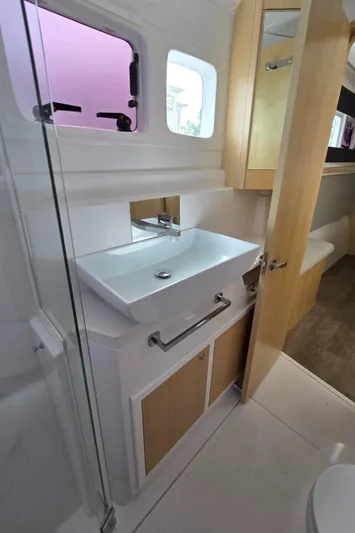  Yacht Photos Pics Modern bathroom in 2025 Seawind 1370 yacht with sleek sink and wooden accents.