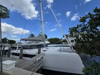  Yacht Photos Pics 2025 Seawind 1370 catamaran docked at marina under blue sky.