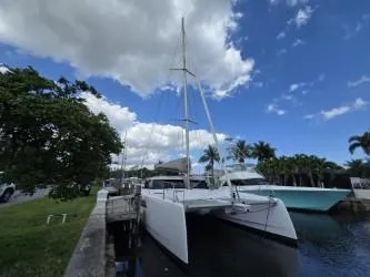  Yacht Photos Pics 2025 Seawind 1370 catamaran docked under a partly cloudy sky.