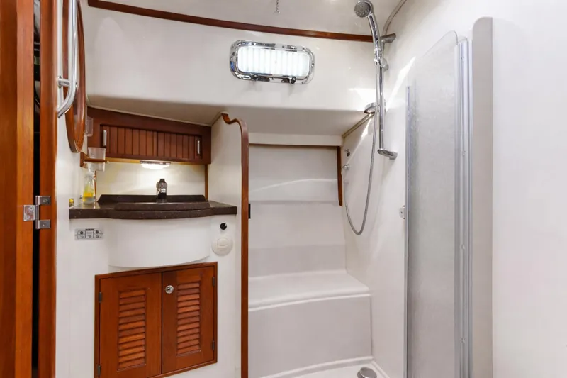 Mawe Yacht Photos Pics Luxurious bathroom interior of 2006 Island Packet 440 yacht with shower and wooden cabinetry.
