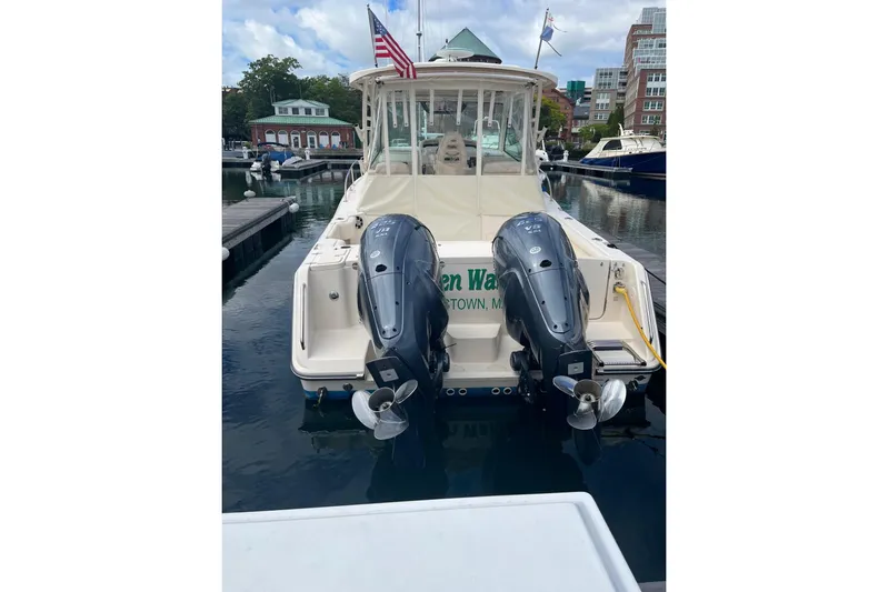 Between Wakes Yacht Photos Pics 2020 Grady-White Express 330 boat docked with dual outboard engines.
