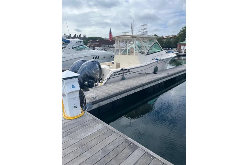 Between Wakes Yacht Photos Pics 2020 Grady-White Express 330 boat docked at marina with twin engines.
