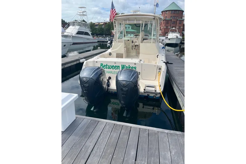 Between Wakes Yacht Photos Pics 2020 Grady-White Express 330 boat docked with twin outboard engines.