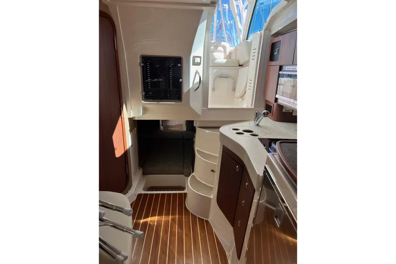 Between Wakes Yacht Photos Pics Interior of 2020 Grady-White Express 330 boat, featuring modern cabinetry and wood flooring.