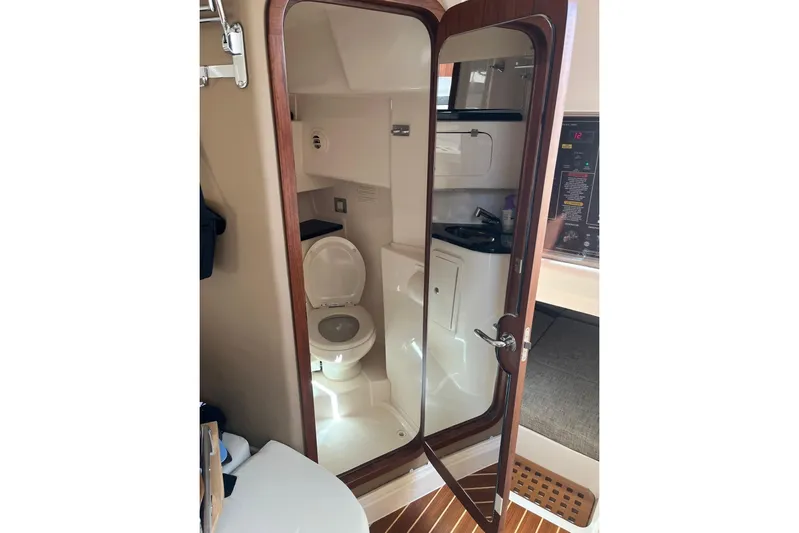 Between Wakes Yacht Photos Pics 2020 Grady-White Express 330 boat interior bathroom with toilet and sink.