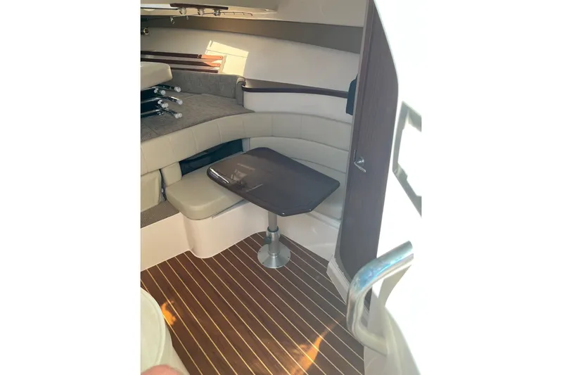 Between Wakes Yacht Photos Pics 2020 Grady-White Express 330 cabin interior with seating and table.