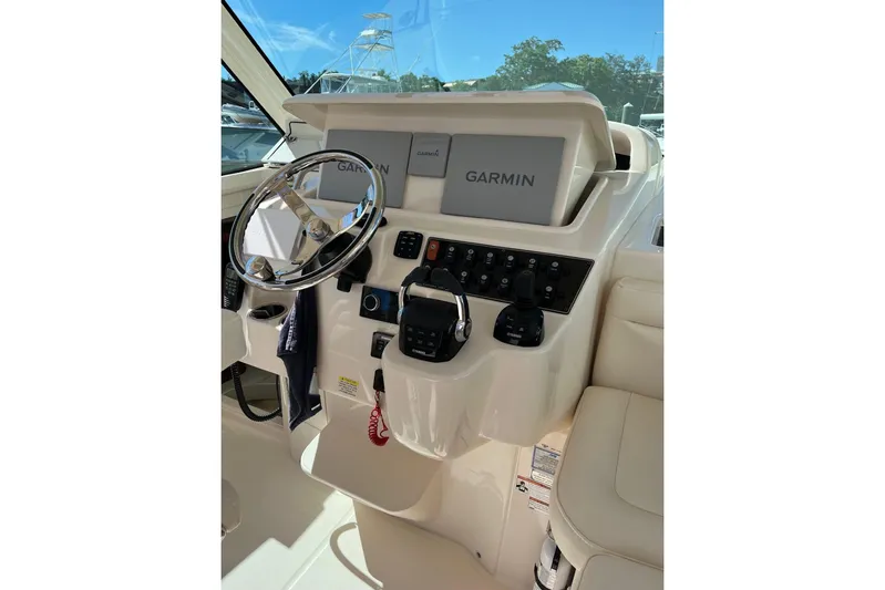 Between Wakes Yacht Photos Pics 2020 Grady-White Express 330 helm with Garmin navigation system and controls.