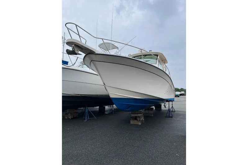 Between Wakes Yacht Photos Pics 2020 Grady-White Express 330 boat on stands, viewed from the front.