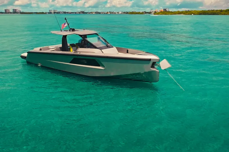Mako Yacht Photos Pics 2024 Maori 46ft yacht anchored in clear turquoise waters under a sunny sky.