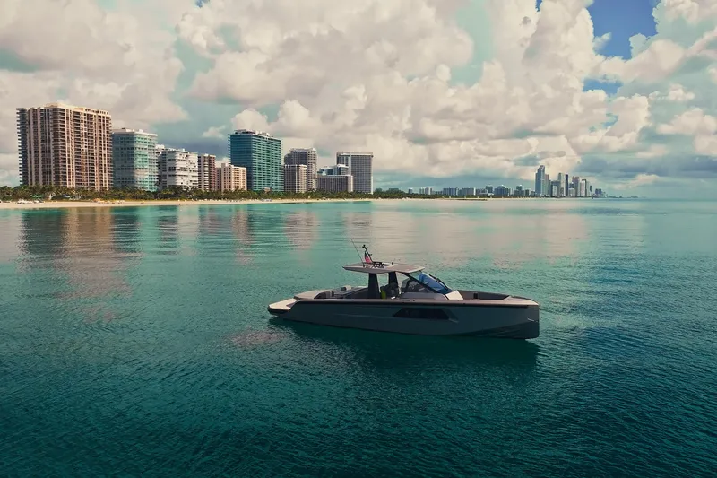 Mako Yacht Photos Pics 2024 Maori 46ft yacht on calm waters with city skyline and clouds in background.