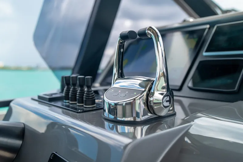 Mako Yacht Photos Pics Control panel of 2024 Maori 46ft yacht with sleek chrome throttle and joystick controls.