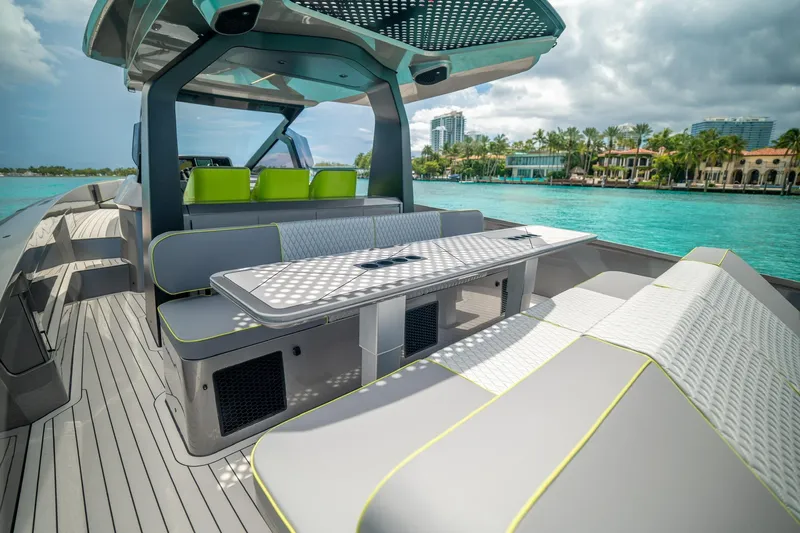 Mako Yacht Photos Pics Luxurious 2024 Maori 46ft yacht with modern seating, cruising on turquoise waters.