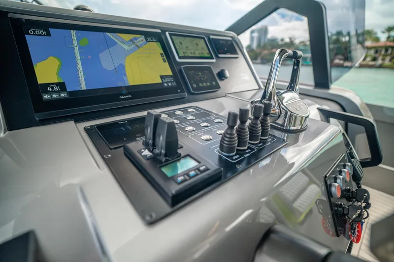 Mako Yacht Photos Pics Control panel of 2024 Maori 46ft yacht with navigation screens and throttle levers.