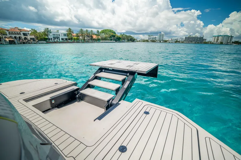 Mako Yacht Photos Pics Luxury Maori 46ft yacht with extended swim platform, 2024 model, on turquoise water.