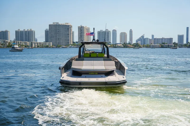 Mako Yacht Photos Pics 2024 Maori 46ft yacht cruising near city skyline on a sunny day.