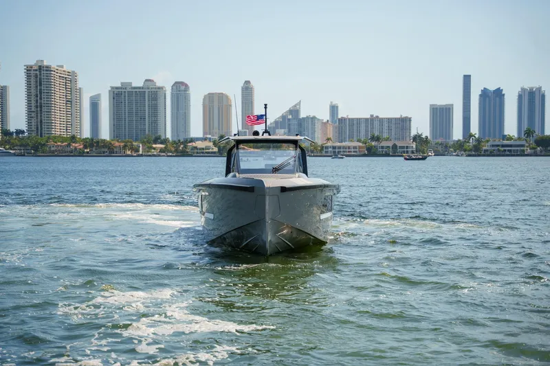 Mako Yacht Photos Pics 2024 Maori 46ft yacht cruising near city skyline on a sunny day.