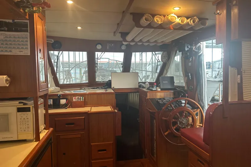 Phoenix Yacht Photos Pics Interior of 2000 Island Gypsy 36 boat with wooden helm and navigation equipment.