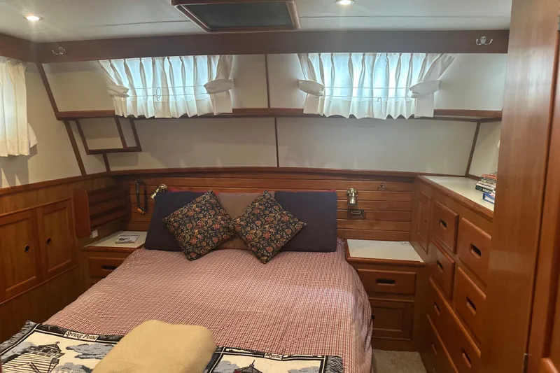 Phoenix Yacht Photos Pics Cozy cabin interior of 2000 Island Gypsy 36 with wood paneling and bed.