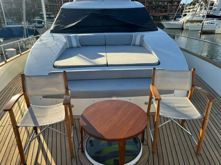  Yacht Photos Pics 1998 Azimut 85 Ultimate yacht deck with chairs and table, marina background.