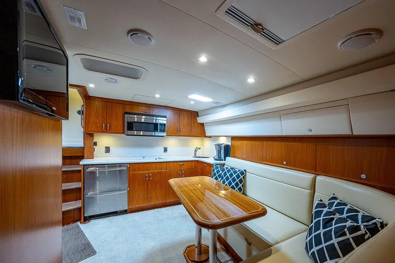 Wanted Yacht Photos Pics Luxurious interior of 2012 Cabo 44 HTX yacht with modern kitchen and seating area.