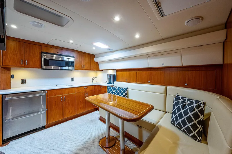 Wanted Yacht Photos Pics Luxurious interior of 2012 Cabo 44 HTX yacht with modern kitchen and seating area.
