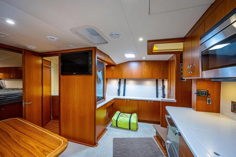Wanted Yacht Photos Pics Luxurious interior of 2012 Cabo 44 HTX yacht with wood finish and modern amenities.