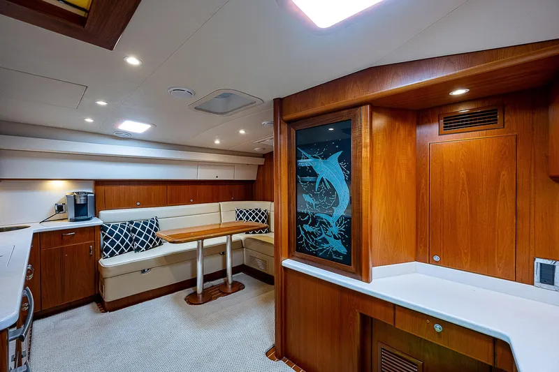 Wanted Yacht Photos Pics Luxurious interior of 2012 Cabo 44 HTX yacht with wood finish and seating area.