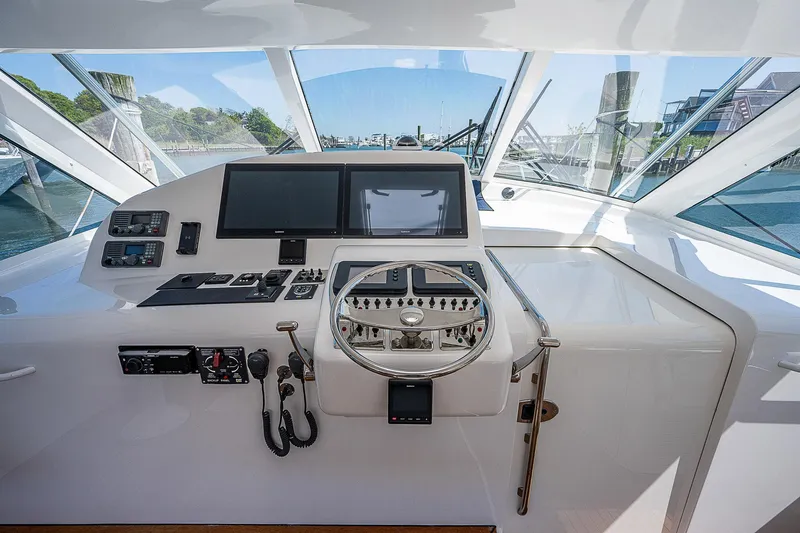 Wanted Yacht Photos Pics Helm of 2012 Cabo 44 HTX yacht with modern navigation equipment.